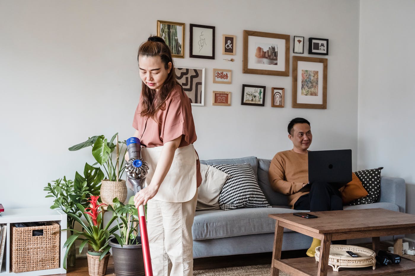 Vacuuming a bright living room during domestic cleaning